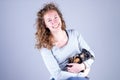 Part of a smiling female, she lovingly holds a tiny sleeping Jack Russel Terrier puppy in her arms Royalty Free Stock Photo