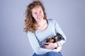 Part of a smiling female, she lovingly holds a tiny sleeping Jack Russel Terrier puppy in her arms Royalty Free Stock Photo