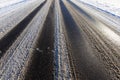 Part of the snow-covered asphalt road close up Royalty Free Stock Photo