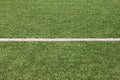 Part of sport soccer stadium and artificial turf football field. Detail, close up of green grass with white lines, goal line. Royalty Free Stock Photo