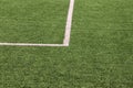 Part of sport soccer stadium and artificial turf football field. Detail, close up of green grass with white lines, goal line. Royalty Free Stock Photo