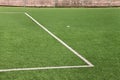 Part of sport soccer stadium and artificial turf football field. Detail, close up of green grass with white lines, goal line. Royalty Free Stock Photo