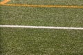 Part of sport soccer stadium and artificial turf football field. Detail, close up of green grass with white lines, goal line. Royalty Free Stock Photo