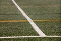 Part of sport soccer stadium and artificial turf football field. Detail, close up of green grass with white lines, goal line. Royalty Free Stock Photo