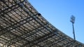 part of the stadium roof with a floodlight tower against the sky Royalty Free Stock Photo