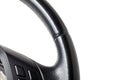 Part of the steering wheel of a car on a white background in a black studio made of smooth leather before installing equipment Royalty Free Stock Photo