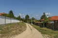 Part of street in the Paunovo village with old house, tree and fence, Sredna Gora mountain Royalty Free Stock Photo