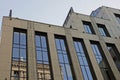 Part of a tall building of brown concrete and blue glass Royalty Free Stock Photo