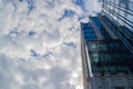 Part of a tall modern office building on the left against a cloudy sky Royalty Free Stock Photo