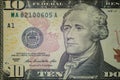 Macro. Part of the ten-dollar bill of the United States with a portrait of Hamilton and a serial number. Close-up. High detail