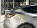 part of Tesla car model Y in liquid silver Mercury Silver Metallic color in Studio, electric vehicle in showroomr, alternative