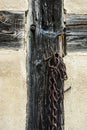 Part of a truss with a rusted chain attached to a nail, Teil einers Fachwerks mit einer an einem Nagel aufghÃÂ¤ngten verr