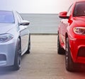 Part two cars on the background of sky and metal fence. Two cars standing side by side