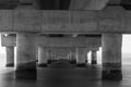 part under the Vasco da Gama bridge in perspective of infinity with the supporting pillars visible.