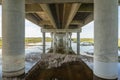 part under the Vasco da Gama bridge in perspective of infinity with the supporting pillars visible.