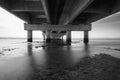 part under the Vasco da Gama bridge in perspective of infinity with the supporting pillars visible.