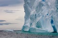 Very huge Iceberg with escarpment with reflections shining turquoise in Arctic water