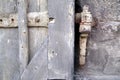 Part of a very old window shutter with flaky paint and rust