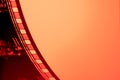 Part of vintage filmstrip in soft red light. Analog old strips of film for a photo or video camera close up. Selective Royalty Free Stock Photo