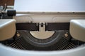 Part of a vintage typewriter with a paper sheet and copy space, may be used as a contact and mail symbol or for a writing blog,