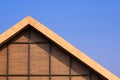 Part of vintage wooden gable roof with battens decoration against blue clear sky background Royalty Free Stock Photo