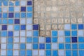 part of a wall in blue mosaic close-up on a gray plastered wall Royalty Free Stock Photo