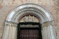 Part of a wall with studded door of the cathedral of Cream in the province of Cremona in Lombardy (Italy)