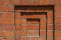 Part of the wall of a 19th century building made of old red brick. Urban background with a beautiful shape in Royalty Free Stock Photo