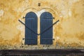 Part of wall with vintage closed windows. Detail of old colonial building in Sri lanka