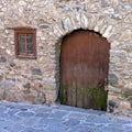 Part of the wall with a window and a door in the very old house, built in the 16th century Royalty Free Stock Photo