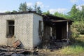 Part of a white brick destroyed house after a fire on the street