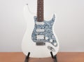 Part of white electric guitar, studio shoot. 2 x Single Coil and 1 x Humbucker. Black Pearl pickguard, Rosewood Fingerboard