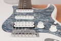 Part of white electric guitar, studio shoot.  2 x Single Coil and 1 x Humbucking. Black Pearl pickguard, Rosewood Fingerboard Royalty Free Stock Photo