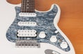 Part of white electric guitar, studio shoot.  2 x Single Coil and 1 x Humbucking. Black Pearl pickguard, Rosewood Fingerboard Royalty Free Stock Photo