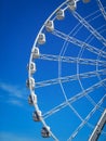 part of white ferris wheel against blue sky background Royalty Free Stock Photo