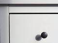 Part of a white modern wooden chest of drawers Royalty Free Stock Photo