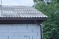 part of a white private brick house under a gray slate roof Royalty Free Stock Photo