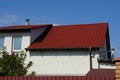 Part of a white private house with a window under a red tiled roof Royalty Free Stock Photo