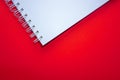 A part of white spiral notebook on red background Royalty Free Stock Photo