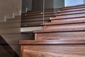 Part of wooden steps with glass railings. Walnut staircase Royalty Free Stock Photo