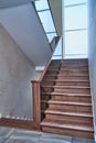 Part of wooden steps with glass railings. Walnut staircase Royalty Free Stock Photo