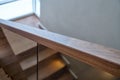 Part of wooden steps with glass railings. Walnut staircase Royalty Free Stock Photo