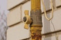 Part of a yellow iron rusty gas pipe with a faucet Royalty Free Stock Photo