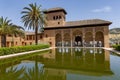 The Partal Palace surrounded by tropical trees and a pool in Alhambra, Granada, Spain