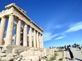 Photography of tourists visiting the majestic Parthenon temple at the top of the Acropolis hill in Athens, Greece. Royalty Free Stock Photo