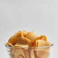Partial bowl of delicious heap of potato chips