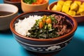 partial bowl of feijoada against a bright, solid background