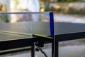 Partial close-up of the net of a ping pong table