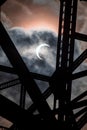 a partial eclipse is seen from underneath the bridge on a cloudy day Royalty Free Stock Photo