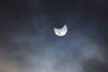Partial eclipse of the sun on a cloudy sky Royalty Free Stock Photo